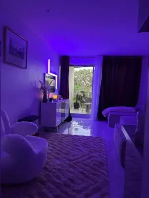 a purple living room with a couch and a table at Appartement luxe Jaccuzi marbre et terrasse in Cannes