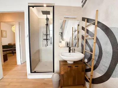 a bathroom with a sink and a shower at Stylish 3-Bedroom Cannes Apartment - Steps from Palais des Festivals in Cannes