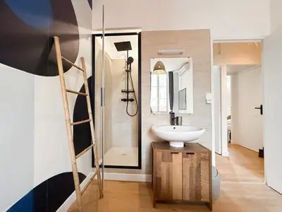 a bathroom with a sink and a mirror at Stylish 3-Bedroom Cannes Apartment - Steps from Palais des Festivals in Cannes