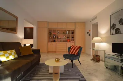 a living room with a couch and a table at Wiosna- Quiet 1 Bedroom in Cannes