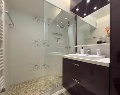 a bathroom with a glass shower and a sink at Wiosna- Quiet 1 Bedroom in Cannes