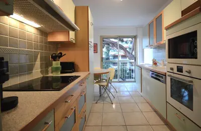 a kitchen with a sink and a stove top oven at Wiosna- Quiet 1 Bedroom in Cannes
