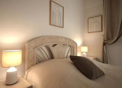 a bedroom with a large bed with two lamps at Wiosna- Quiet 1 Bedroom in Cannes