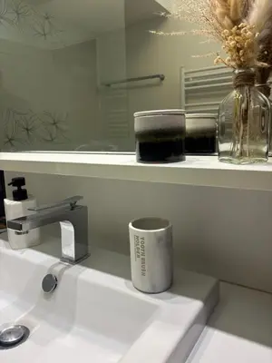 a cup sitting on top of a bathroom sink at Wiosna- Quiet 1 Bedroom in Cannes
