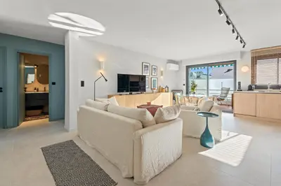 a living room with a white couch and a kitchen at REF 2037 - Apartment for Rent Sea View in Cannes