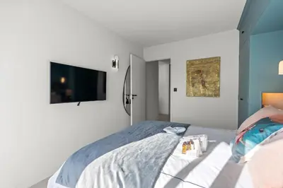 a bedroom with a bed with a tv on the wall at REF 2037 - Apartment for Rent Sea View in Cannes
