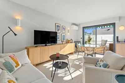 a living room with a couch and a tv and a table at REF 2037 - Apartment for Rent Sea View in Cannes