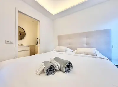 a bedroom with a white bed with towels on it at Cannes 2 bedrooms & 2 bathrooms apartment - 24P2 in Cannes
