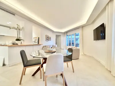 a dining room and kitchen with a glass table and chairs at Cannes 2 bedrooms & 2 bathrooms apartment - 24P2 in Cannes