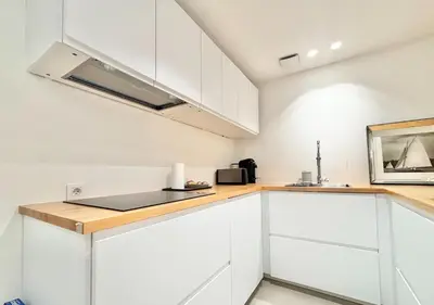 a kitchen with white cabinets and a microwave at Cannes 2 bedrooms & 2 bathrooms apartment - 24P2 in Cannes