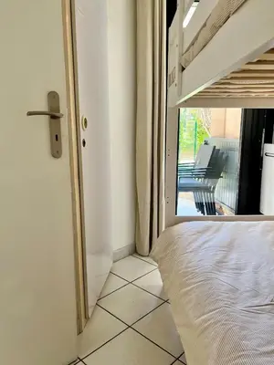 a bedroom with a bed and a view of a patio at Sea Cocoon La Bocca in Cannes