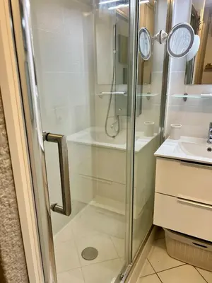 a shower with a glass door next to a sink at Sea Cocoon La Bocca in Cannes