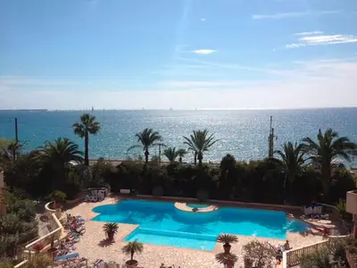 a large swimming pool with the ocean in the background at Sea Cocoon La Bocca in Cannes
