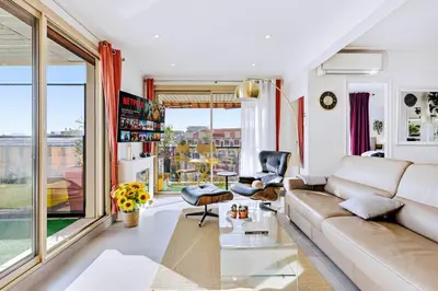 a living room with a couch and a glass table at Jardin d'Eden - Incroyable Rooftop Jardin suspendu in Cannes