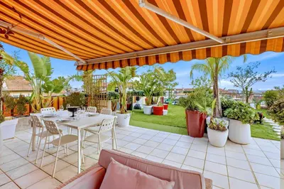 an outdoor patio with a table and chairs at Jardin d'Eden - Incroyable Rooftop Jardin suspendu in Cannes