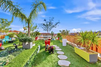 a backyard with two horses grazing on the grass at Jardin d'Eden - Incroyable Rooftop Jardin suspendu in Cannes