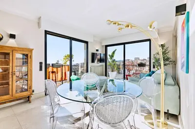 a balcony with green grass and a table and chairs at Septieme Ciel - Exceptionnel Appartement vue Mer in Cannes