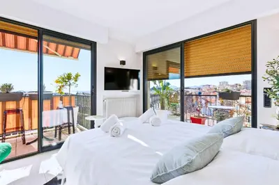 a living room with a couch and a table and chairs at Septieme Ciel - Exceptionnel Appartement vue Mer in Cannes