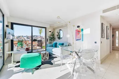 a living room with a blue couch and chairs at Septieme Ciel - Exceptionnel Appartement vue Mer in Cannes