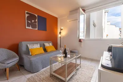 a bedroom with a white bed and a window at My Studio in Center of Cannes in Cannes