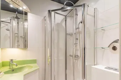 a bathroom with a glass shower and a sink at Cozy studio in the heart of Cannes - Near sea in Cannes