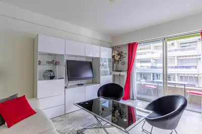 a living room with a couch and two chairs and a tv at Cozy studio in the heart of Cannes - Near sea in Cannes