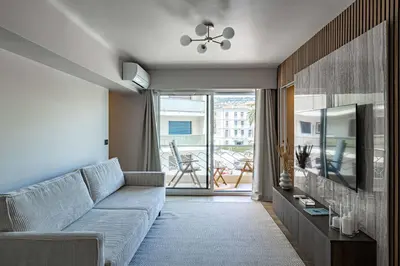 a living room with a couch and a television at Apartment for 4people in Martinez in Cannes