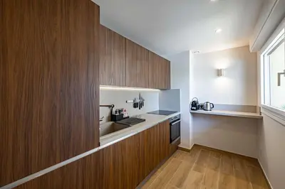 a small kitchen with wooden cabinets and a sink at Apartment for 4people in Martinez in Cannes
