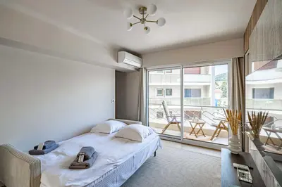 a bedroom with a bed and a large window at Apartment for 4people in Martinez in Cannes