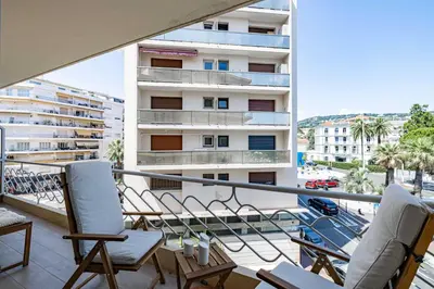 a balcony with chairs and a view of a building at Apartment for 4people in Martinez in Cannes