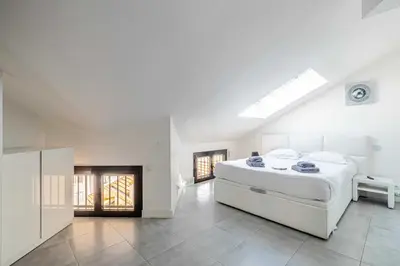 a white bedroom with a large bed and a skylight at Luxury Penthouse 120mÂ² in the heart of Cannes in Cannes