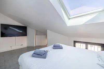 a bedroom with a large bed with two towels on it at Luxury Penthouse 120mÂ² in the heart of Cannes in Cannes