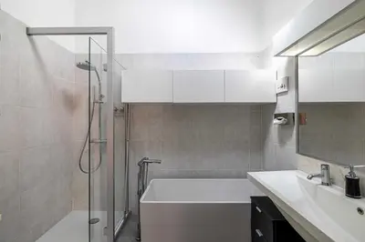 a bathroom with a shower and a sink and a tub at Luxury Penthouse 120mÂ² in the heart of Cannes in Cannes