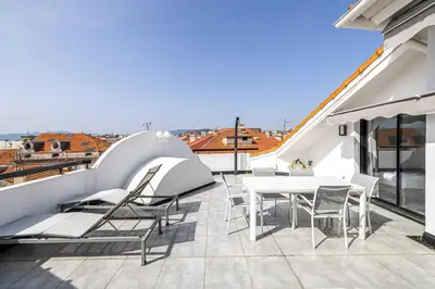 a balcony with a table and chairs on a building at Luxury Penthouse 120mÂ² in the heart of Cannes in Cannes