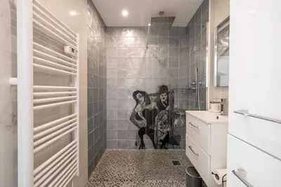 a bathroom with a mural of a man and a woman at Charming studio near the Croisette in Cannes