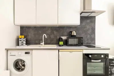 a kitchen with a sink and a washing machine at Charming studio near the Croisette in Cannes