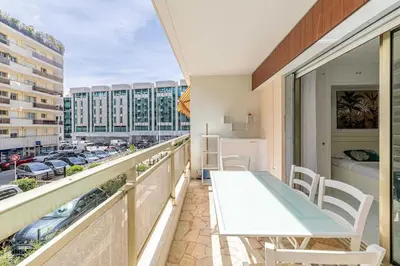 a balcony with a table and a view of a city at Charming studio near the Croisette in Cannes