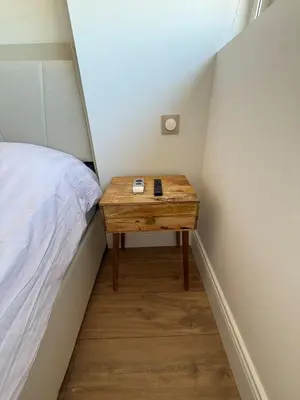 a small table next to a bed in a small room at Roof top Luxe Cannes in Cannes
