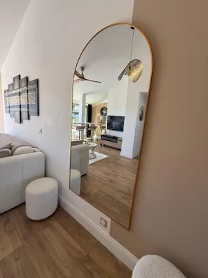 a living room with a large mirror on the wall at Roof top Luxe Cannes in Cannes