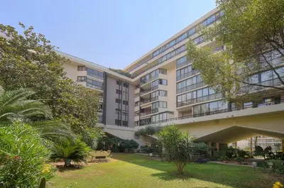 an apartment building with a lawn in front of it at PROCHE CARLTON One bedroom Apartment in Cannes