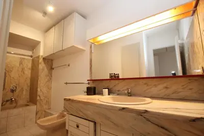 a bathroom with a sink and a mirror at PROCHE CARLTON One bedroom Apartment in Cannes