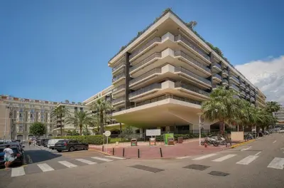 a large apartment building on a city street at PROCHE CARLTON One bedroom Apartment in Cannes