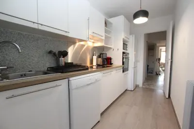 a kitchen with white cabinets and a sink at PROCHE CARLTON One bedroom Apartment in Cannes