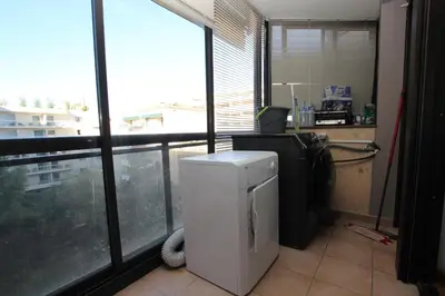 a room with a refrigerator and a large window at PROCHE CARLTON One bedroom Apartment in Cannes