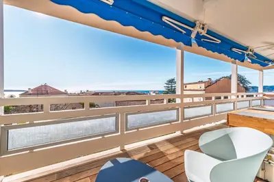 a balcony with a view of the water at Marius By Terrys Homes in Cannes
