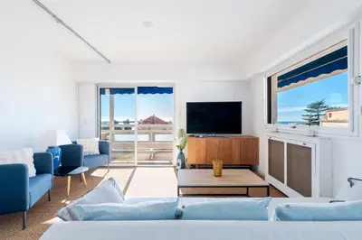 a living room with a couch and a tv at Marius By Terrys Homes in Cannes