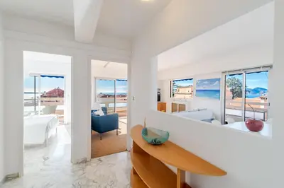 a white living room with a table and chairs at Marius By Terrys Homes in Cannes