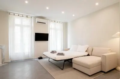 a living room with a white couch and a chair at Quiet and luxurious apartment - Cannes Center - 2BR 6p in Cannes