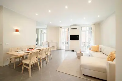 a living room with a table and a white couch at Quiet and luxurious apartment - Cannes Center - 2BR 6p in Cannes