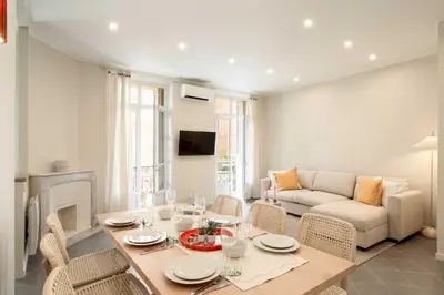 a living room with a table and a couch at Quiet and luxurious apartment - Cannes Center - 2BR 6p in Cannes